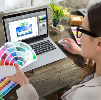 woman working with a color of logo using laptop
