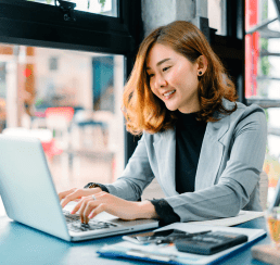 woman smiling while using laptop